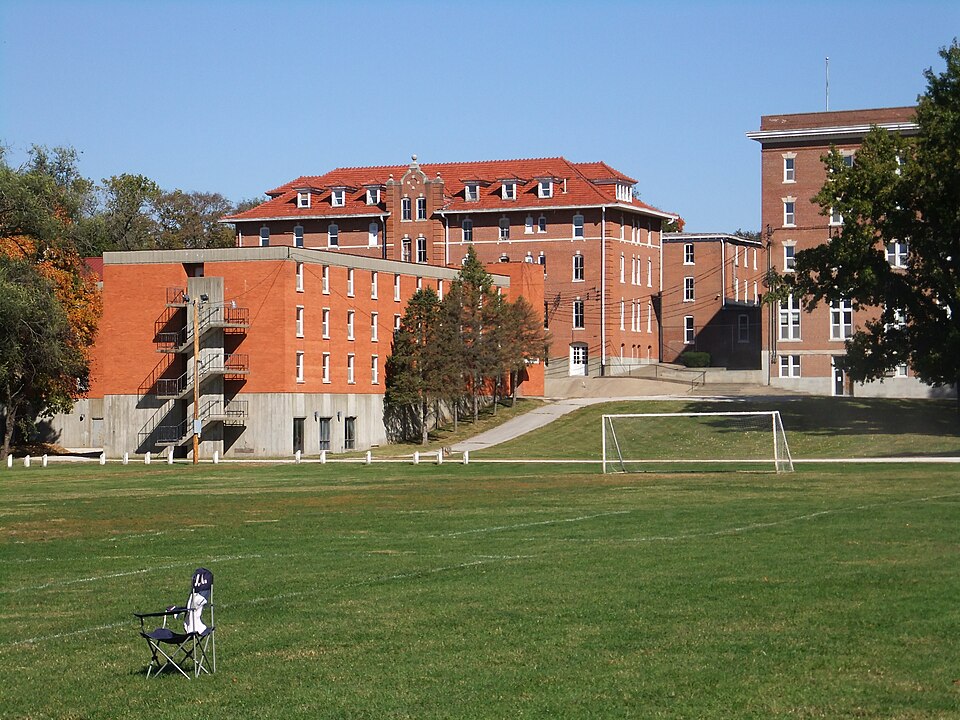Former Kemper Military School brick campus buildings and playing field in Boonville, Missouri; a contextual campus view.