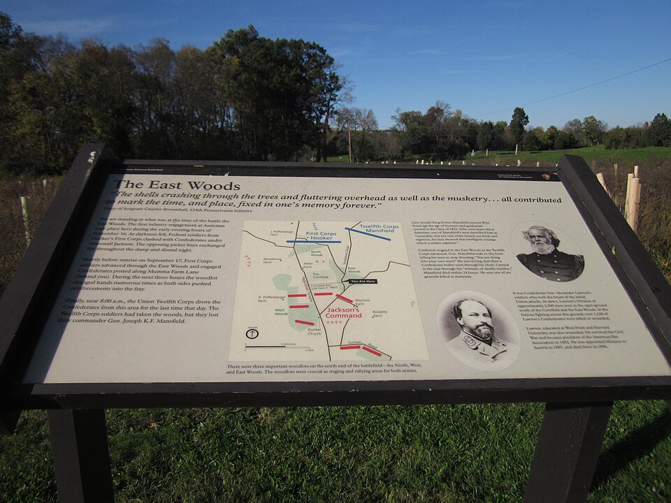 The East Woods interpretive panel and surrounding landscape at Antietam National Battlefield; a site detail, not a panoramic view.