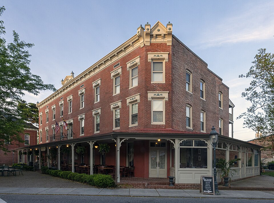 Atlantic Hotel brick exterior and covered street-level porch in Berlin, Maryland.