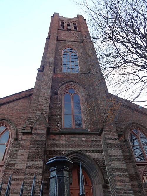 Brick entrance tower and pointed-arch windows of Westminster Hall in Baltimore, Maryland.