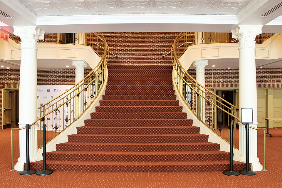 Interior foyer and red-carpeted staircase of the Maryland Theatre in Hagerstown, Maryland.