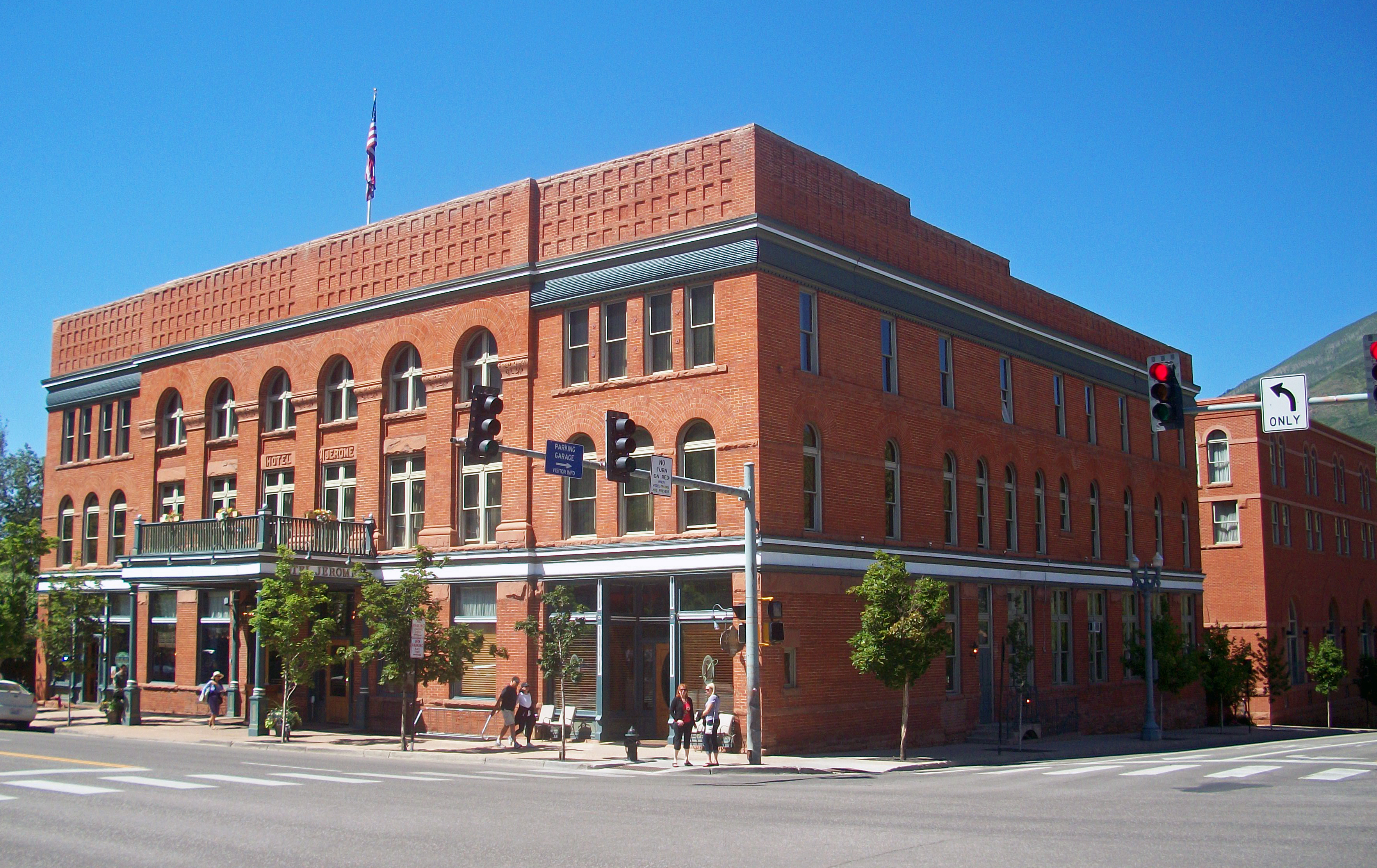 Red brick Hotel Jerome exterior with the corner facade and street visible in Aspen, Colorado.