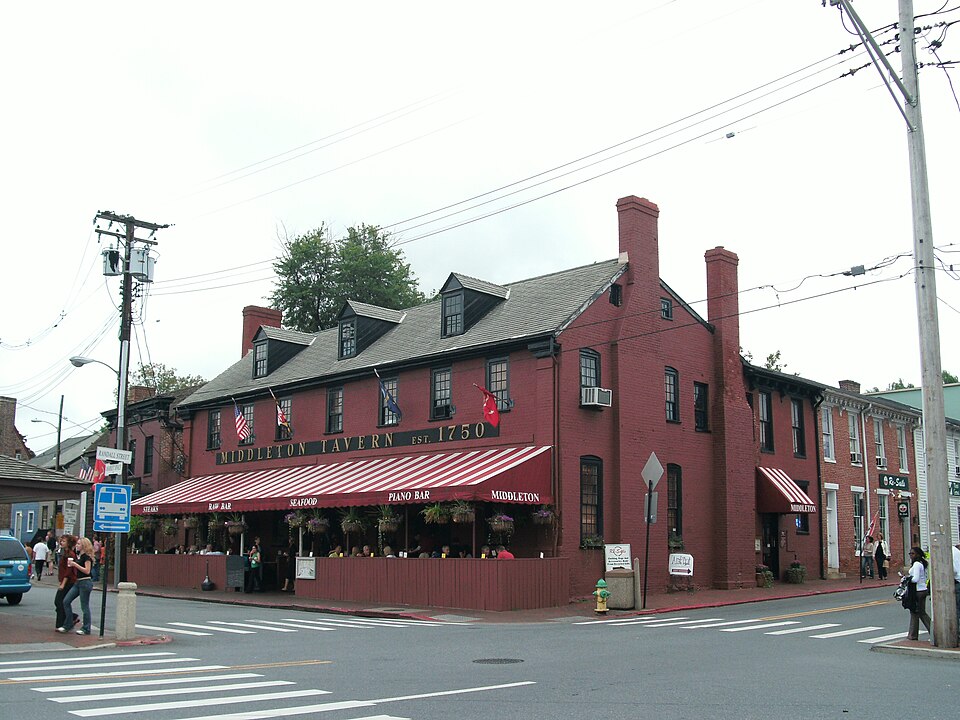 Red exterior and street-facing awning of Middleton Tavern in Annapolis, Maryland.