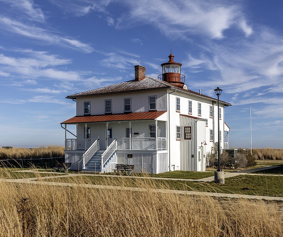 Point Lookout Lighthouse exterior among coastal grasses at Point Lookout State Park, Maryland.