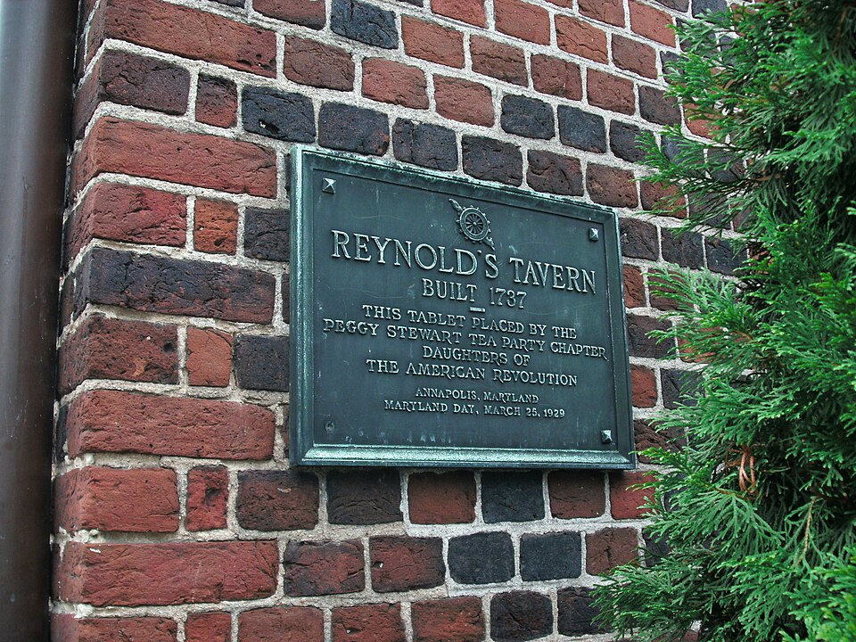 A plaque identifying Reynolds Tavern on a brick wall in Annapolis, Maryland; a site detail rather than an exterior view.
