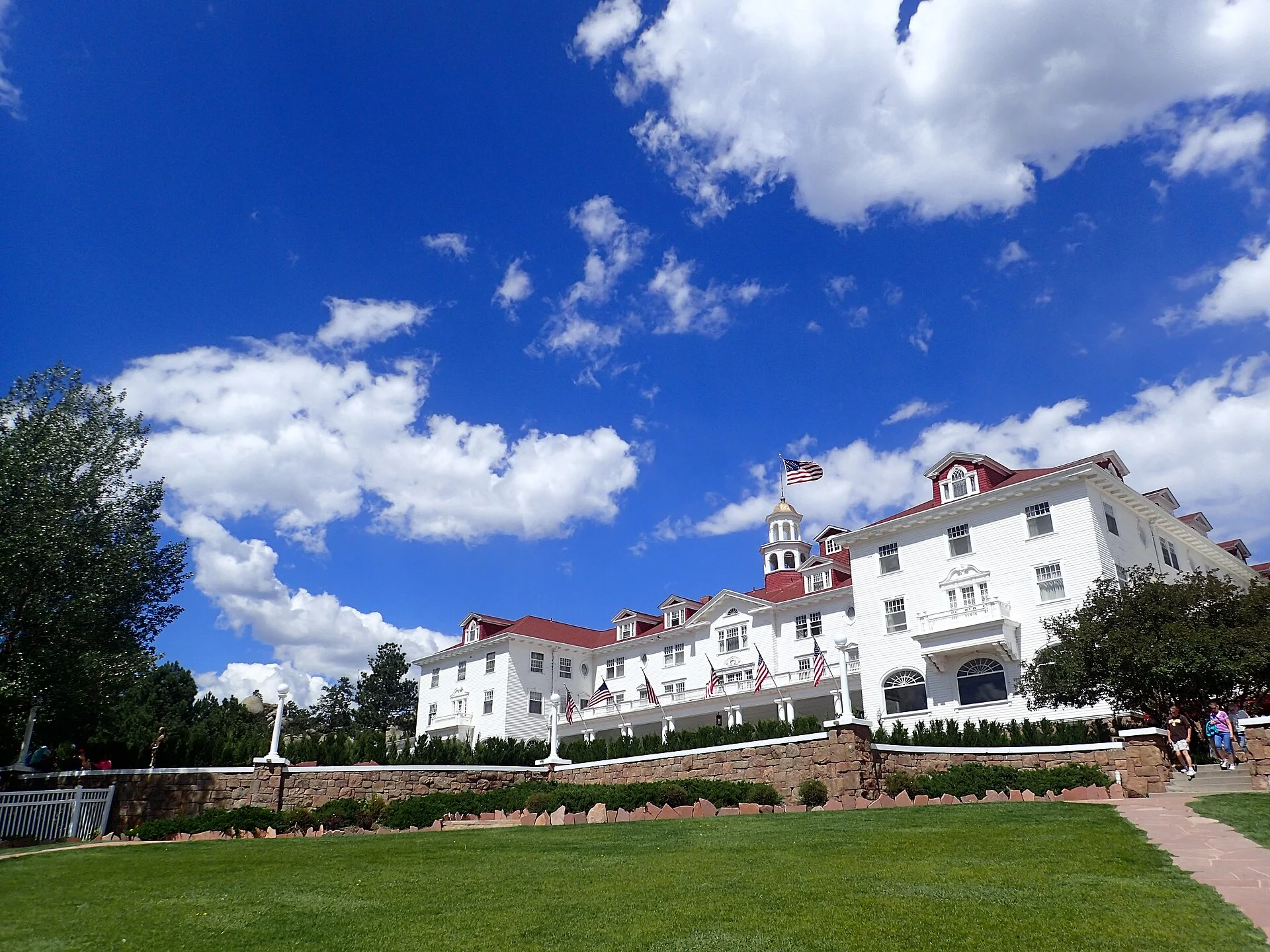 The Stanley Hotel’s white façade and red roof beneath a Colorado sky.
